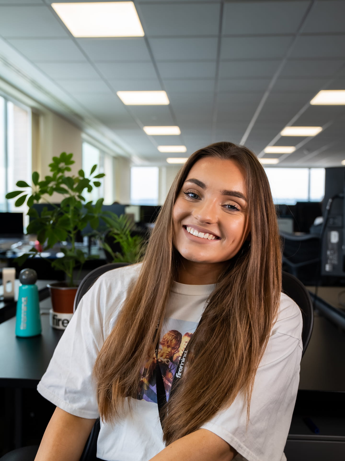 Jessica Waving sitting in office, smiling