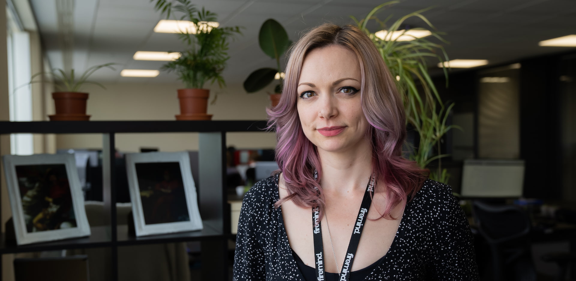 Image of Vix Johnson in front of Firemind display area