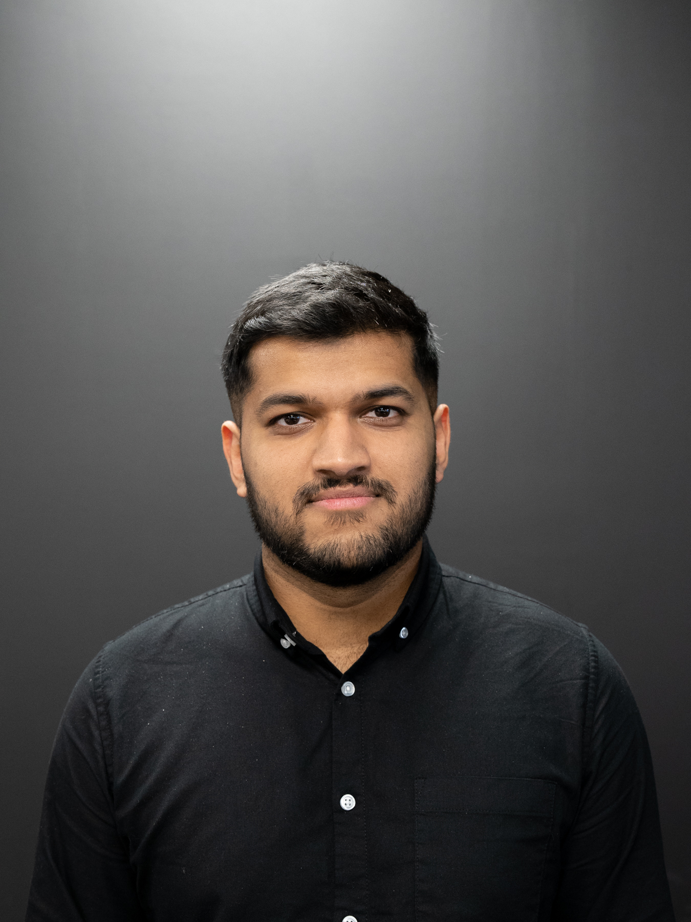 Jason Mathew, Cloud Engineer, in front of black background